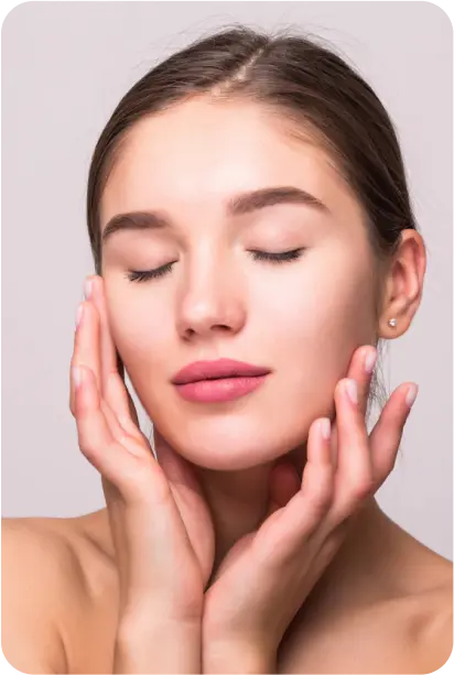 female model posing with her eyes closed and her hands on her cheeks
