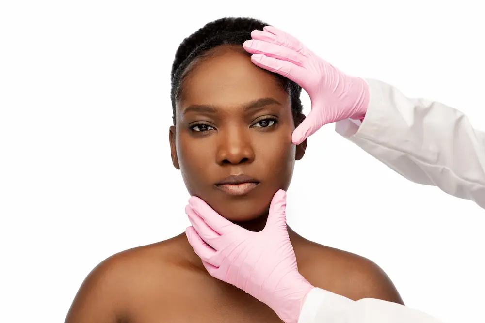 young African american woman and hands in medical gloves over white background